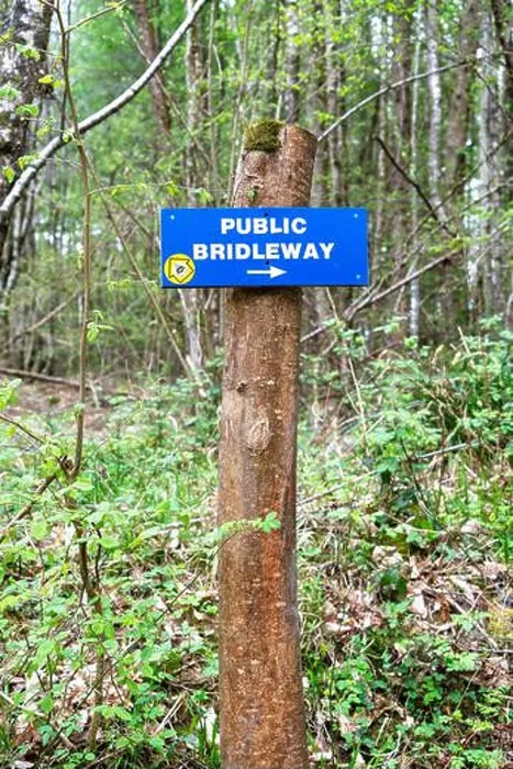 Framed Print : Public bridleway sign attached to a wooden post in woodland Framed Print : Public bridleway sign attached to a wooden post in woodland