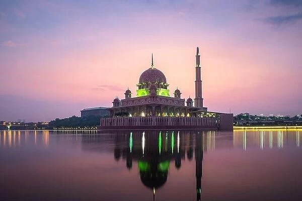 Putrajaya mosque or pink mosque with lake between sunrise in Kuala Lumpur, Malaysia. Malaysia tourism, history building, or tradition culture and trav