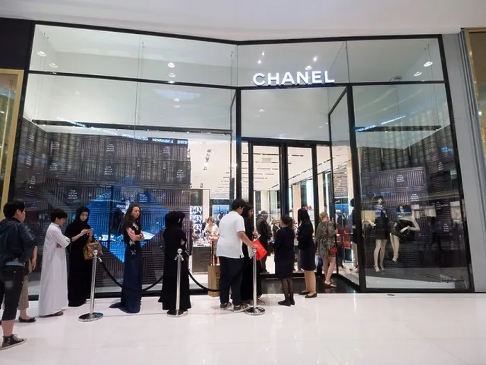 Framed Print : Queue of shoppers outside Chanel boutique at The Dubai Mall in Dubai United Arab Emirates Framed Print : Queue of shoppers outside Chanel boutique at The Dubai Mall in Dubai United Arab Emirates