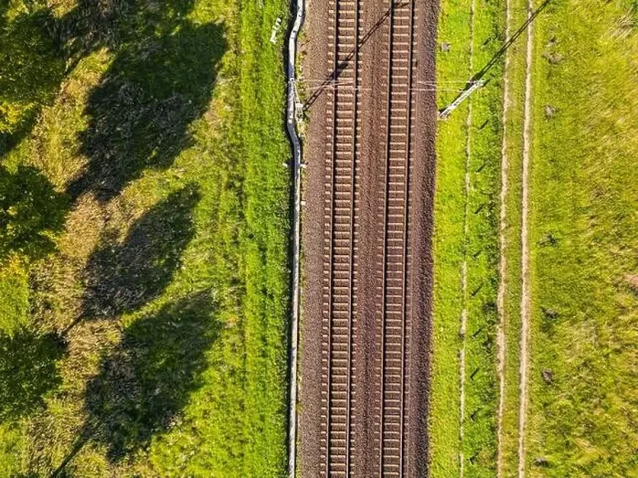 Framed Print : A railroad track with two lanes of tracks passes through nature directly from above as an aerial shot Framed Print : A railroad track with two lanes of tracks passes through nature directly from above as an aerial shot