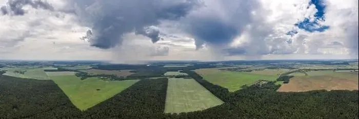Framed Print : Rain over rural countryside aerial panorama. Rain clouds shot from a drone Framed Print : Rain over rural countryside aerial panorama. Rain clouds shot from a drone