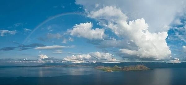 A full rainbow stretches across the sky near Flores, Indonesia. This beautiful region has both a wet and a dry season