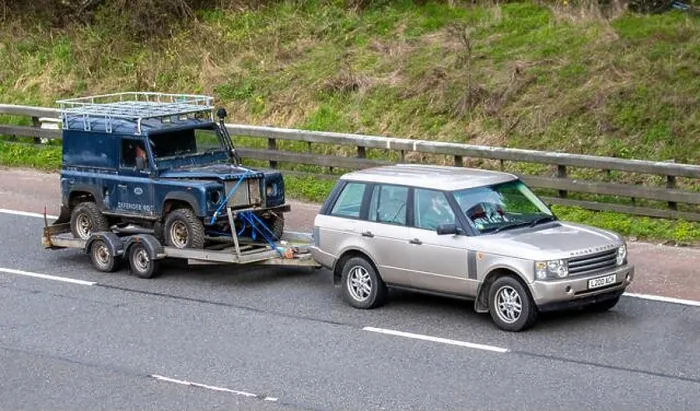 Framed Print : Range Rover towing decrepit dilapidated old Land Rover Defender Framed Print : Range Rover towing decrepit dilapidated old Land Rover Defender