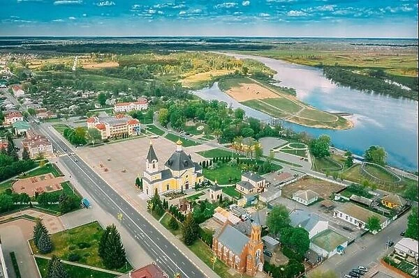 Rechytsa, Belarus. Aerial View Of Residential Houses, River Dnieper And Holy Assumption Cathedral In Sunny Summer Day. Top View. Drone View. Bird's