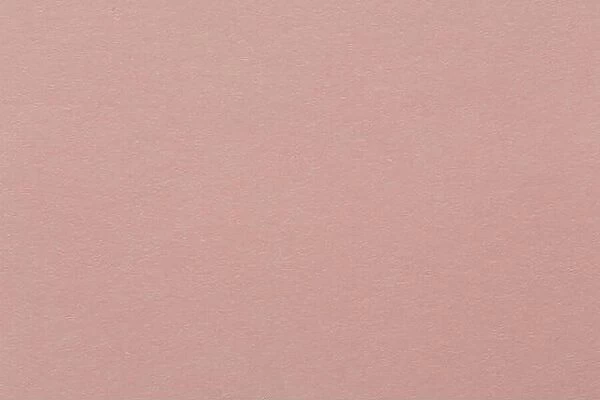 Recycled craft paper textured background in light pink old rose color