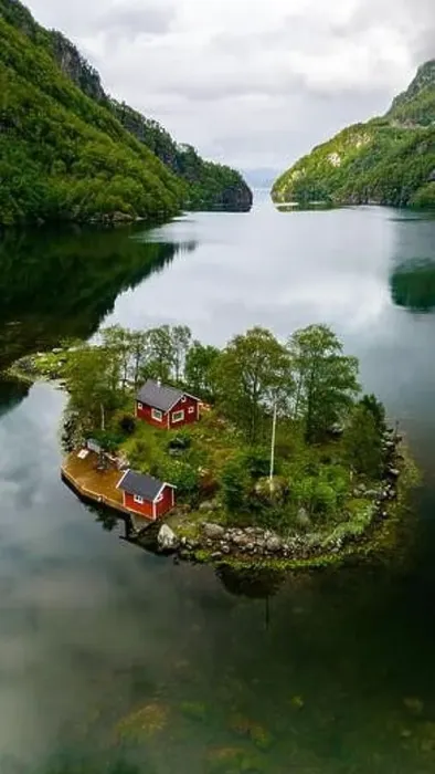 Framed Print : A red cabin nestled on a small island in a fjord surrounded by green mountains and calm water. Lovrafjorden, Norway Framed Print : A red cabin nestled on a small island in a fjord surrounded by green mountains and calm water. Lovrafjorden, Norway