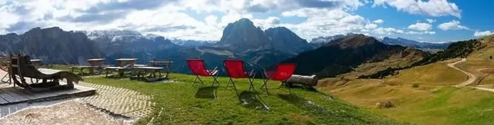 Framed Print : Red lawn chairs with dramtic Mountain background. Dolomites in European Alps. Gardena Pass, Italy. Vacation Theme Framed Print : Red lawn chairs with dramtic Mountain background. Dolomites in European Alps. Gardena Pass, Italy. Vacation Theme