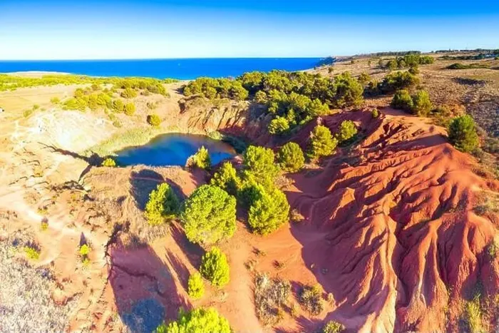 Framed Print : Red rocks of the bauxite quarry abandoned mine and lake, aerial view, Otranto, Lecce province, Apulia, Italy Framed Print : Red rocks of the bauxite quarry abandoned mine and lake, aerial view, Otranto, Lecce province, Apulia, Italy