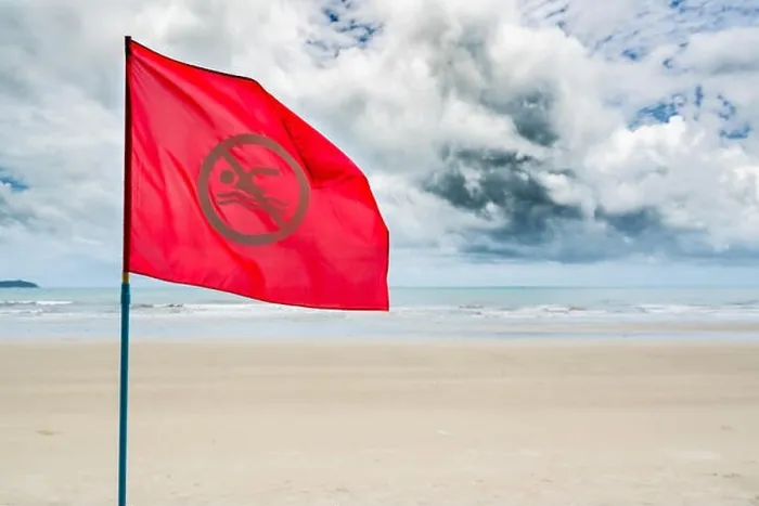 Framed Print : Red no swimming flag warning for tourist not to swim during storm coming in the sea Framed Print : Red no swimming flag warning for tourist not to swim during storm coming in the sea