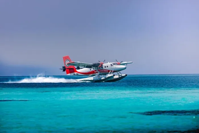 Framed Print : Red and white seaplane approaching island in the Maldives. Transmaldivian airlines in Maldives island Framed Print : Red and white seaplane approaching island in the Maldives. Transmaldivian airlines in Maldives island