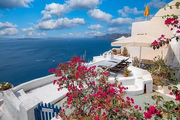 Relaxing and romantic view with white architecture in Santorini Greece, caldera view over blue sea and volcano island. Summer landscape for travelling