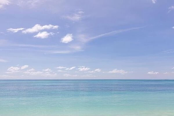 Relaxing tropical seascape with wide horizon of the sky and the sea. Peaceful ocean water, surf, waves, calmness concept. Endless sea horizon