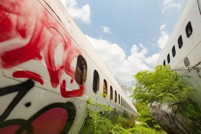 Framed Print : Remains of a wrecked and graffitied Boeing 747 and two McDonnell Douglas MD-80s in a field in Bangkok Framed Print : Remains of a wrecked and graffitied Boeing 747 and two McDonnell Douglas MD-80s in a field in Bangkok