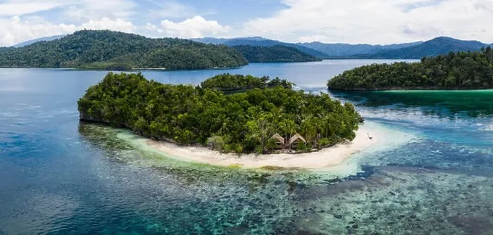 Framed Print : A remote limestone island is surrounded by healthy reef in Raja Ampat, Indonesia. This diverse region is known as the heart of the Coral Triangle Framed Print : A remote limestone island is surrounded by healthy reef in Raja Ampat, Indonesia. This diverse region is known as the heart of the Coral Triangle