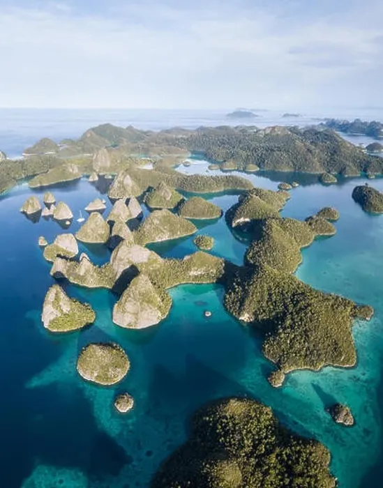 Framed Print : Remote limestone islands form a maze in a tropical lagoon in Raja Ampat, Indonesia. This diverse region is known as the heart of the Coral Triangle Framed Print : Remote limestone islands form a maze in a tropical lagoon in Raja Ampat, Indonesia. This diverse region is known as the heart of the Coral Triangle