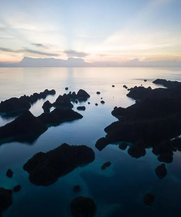 Framed Print : Remote limestone islands form a maze in a tropical lagoon in Raja Ampat, Indonesia. This diverse region is known as the heart of the Coral Triangle Framed Print : Remote limestone islands form a maze in a tropical lagoon in Raja Ampat, Indonesia. This diverse region is known as the heart of the Coral Triangle
