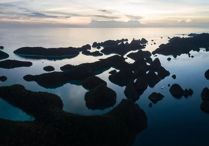 Framed Print : Remote limestone islands form a maze in a tropical lagoon in Raja Ampat, Indonesia. This diverse region is known as the heart of the Coral Triangle Framed Print : Remote limestone islands form a maze in a tropical lagoon in Raja Ampat, Indonesia. This diverse region is known as the heart of the Coral Triangle