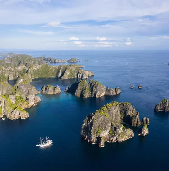 Framed Print : Remote limestone islands rise from the stunning seascape in Raja Ampat, Indonesia. This diverse region is known as the heart of the Coral Triangle Framed Print : Remote limestone islands rise from the stunning seascape in Raja Ampat, Indonesia. This diverse region is known as the heart of the Coral Triangle