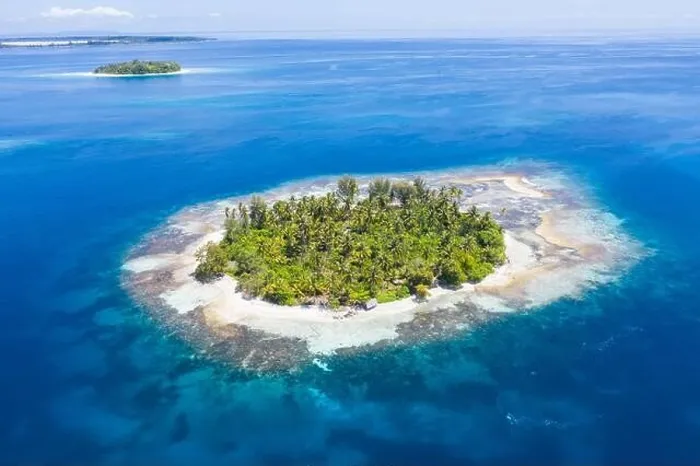 Framed Print : A remote, tropical island in the Molucca Sea, Indonesia, is surrounded by a healthy coral reef. This region is home to incredible marine biodiversity Framed Print : A remote, tropical island in the Molucca Sea, Indonesia, is surrounded by a healthy coral reef. This region is home to incredible marine biodiversity