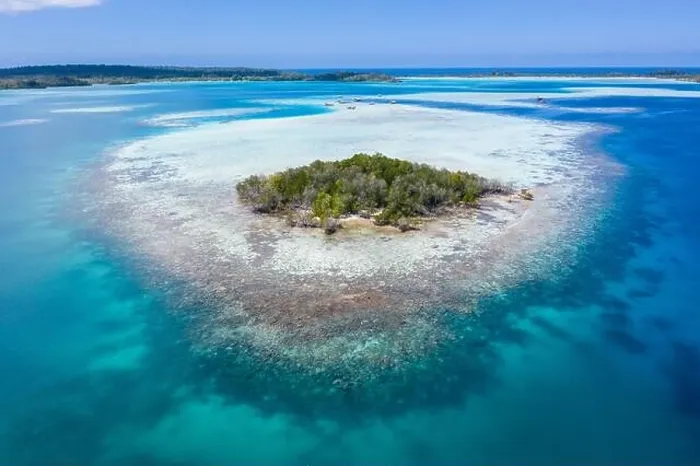 Framed Print : A remote, tropical island in the Molucca Sea, Indonesia, is surrounded by a healthy coral reef. This region is home to incredible marine biodiversity Framed Print : A remote, tropical island in the Molucca Sea, Indonesia, is surrounded by a healthy coral reef. This region is home to incredible marine biodiversity