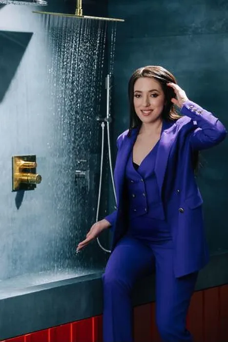Framed Print : Representative saleswoman in purple suit testing overhead shower, water running Framed Print : Representative saleswoman in purple suit testing overhead shower, water running