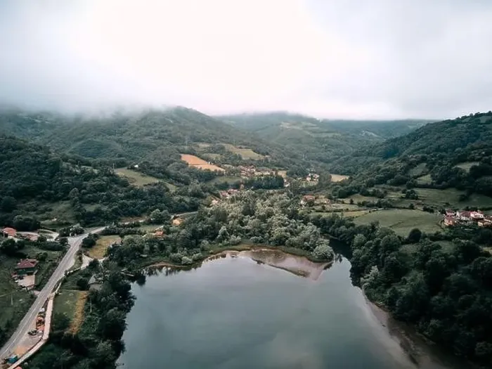Framed Print : reservoir from a drone near the road that surrounds it and the forest vegetation on a cloudy day Framed Print : reservoir from a drone near the road that surrounds it and the forest vegetation on a cloudy day