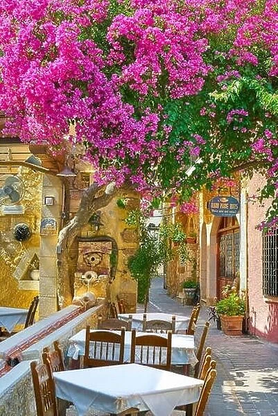 Restaurant at Chania Old Town, blooming flowers, Crete Island, Greece