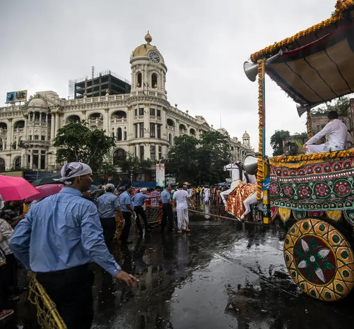 Framed Print : Return journey, Lord Jagannatha, in heavy rains, before heritage Metropolitan Building, Kolkata, India