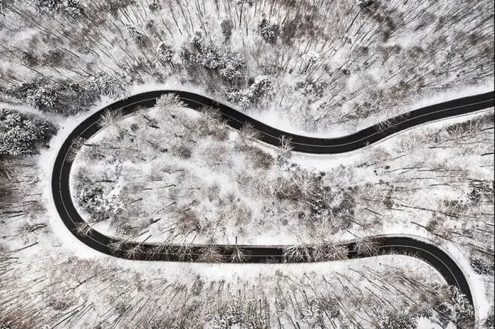 Framed Print : Empty road surrounded by much snow in the winter as a fairytail view from above by drone Framed Print : Empty road surrounded by much snow in the winter as a fairytail view from above by drone