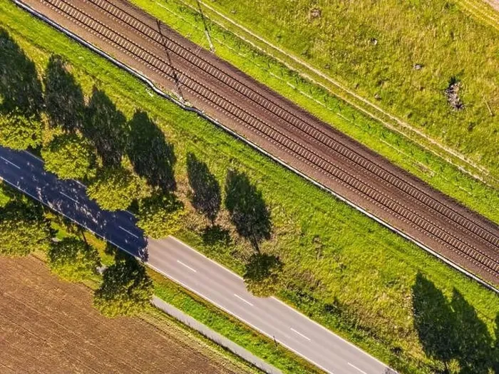 Framed Print : A road, trees and a railroad line directly from above as an aerial view, Germany Framed Print : A road, trees and a railroad line directly from above as an aerial view, Germany