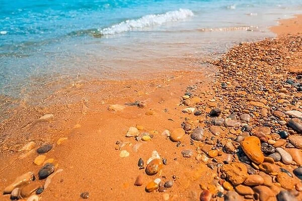 Rocks on the seaside near the beach, pebbles on calm beach