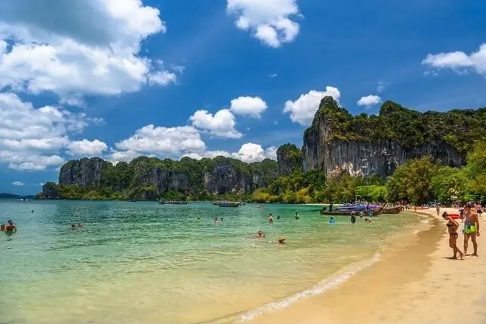 Framed Print : Rocks, water, tropical white sand beach and people swimming in emerald azure water of bay Framed Print : Rocks, water, tropical white sand beach and people swimming in emerald azure water of bay