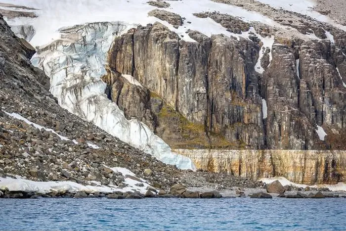 Framed Print : rocks waterfall small iceberg and glacier at the Alkefjellet between Spitsbergen and Nordaustlandet on Svalbard, Norway Framed Print : rocks waterfall small iceberg and glacier at the Alkefjellet between Spitsbergen and Nordaustlandet on Svalbard, Norway