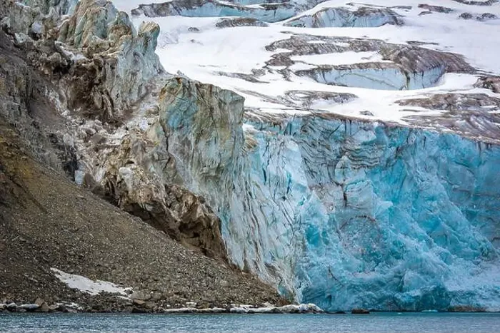 Framed Print : rocks waterfall small iceberg and glacier at the Alkefjellet between Spitsbergen and Nordaustlandet on Svalbard, Norway
