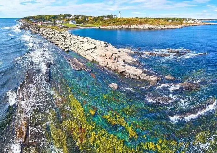 Framed Print : Rocky coastline with shallow waters and waves crashing in Maine and lighthouses in distance Framed Print : Rocky coastline with shallow waters and waves crashing in Maine and lighthouses in distance