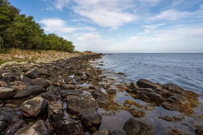 Framed Print : A rocky shoreline with blue water and a blu sky in the background. Picture from Skalderviken, southern Sweden Framed Print : A rocky shoreline with blue water and a blu sky in the background. Picture from Skalderviken, southern Sweden