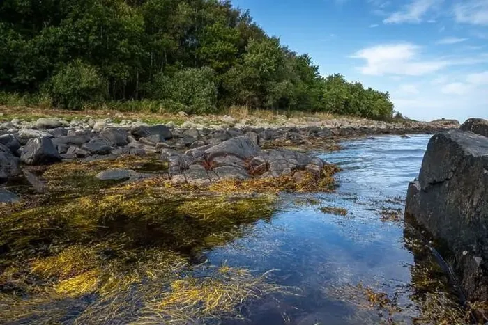Framed Print : A rocky shoreline with blue water and a blu sky in the background. Picture from Skalderviken, southern Sweden Framed Print : A rocky shoreline with blue water and a blu sky in the background. Picture from Skalderviken, southern Sweden