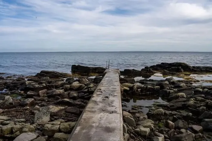 Framed Print : Rocky shoreline with a concrete jetty Framed Print : Rocky shoreline with a concrete jetty