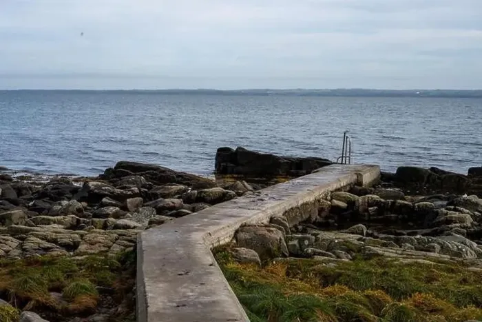 Framed Print : Rocky shoreline with a concrete jetty Framed Print : Rocky shoreline with a concrete jetty