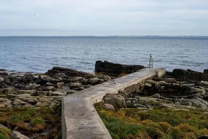 Framed Print : Rocky shoreline with a concrete jetty Framed Print : Rocky shoreline with a concrete jetty