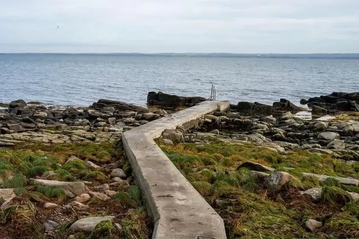 Framed Print : Rocky shoreline with a concrete jetty Framed Print : Rocky shoreline with a concrete jetty