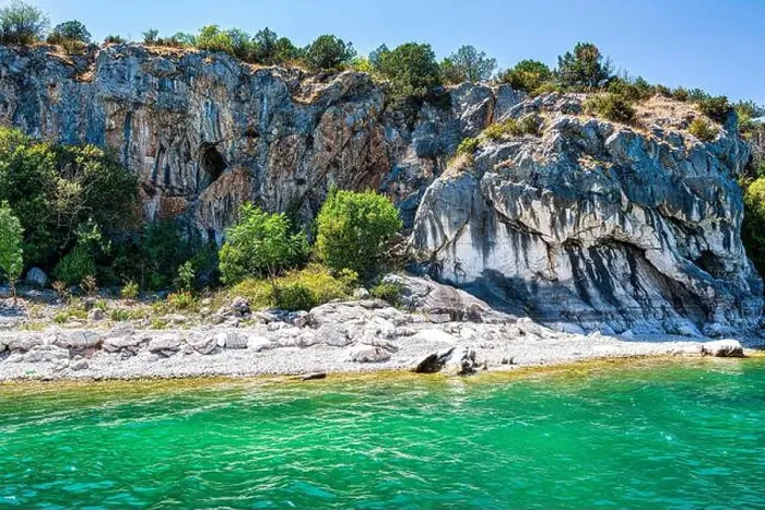 Framed Print : The rocky shoreline of Megali Prespa Lake in Greece