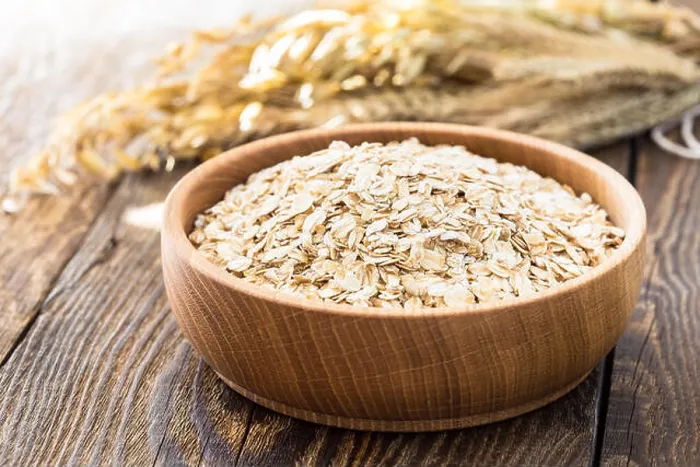Framed Print : Rolled oat flakes in a wooden bowl and oat stalks Framed Print : Rolled oat flakes in a wooden bowl and oat stalks