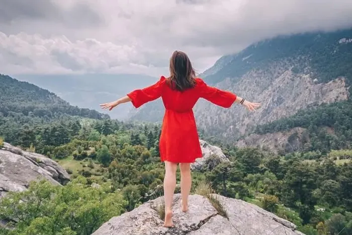 Framed Print : Romantic aerial photo of a girl in a red dress on top of a cliff admiring the view of a mountain gorge Framed Print : Romantic aerial photo of a girl in a red dress on top of a cliff admiring the view of a mountain gorge