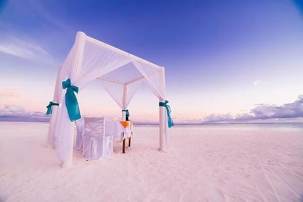 Romantic beach dinner set-up for honeymoon. Beach background concept