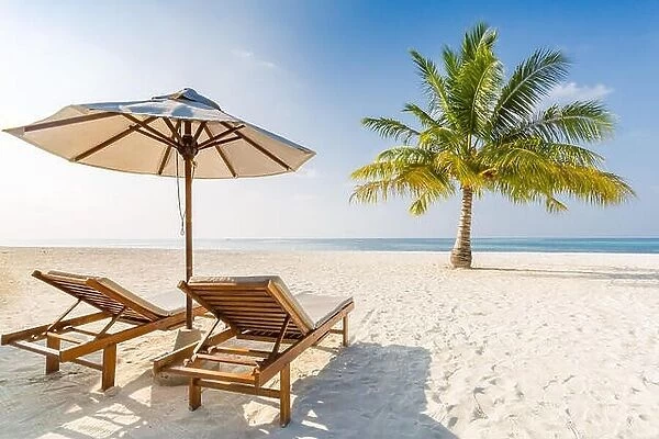 Romantic beach scene, two beach chairs and umbrella