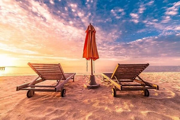 Romantic beach scene, two sun chairs and sunny beach mood. Exotic travel destination and vacation concept