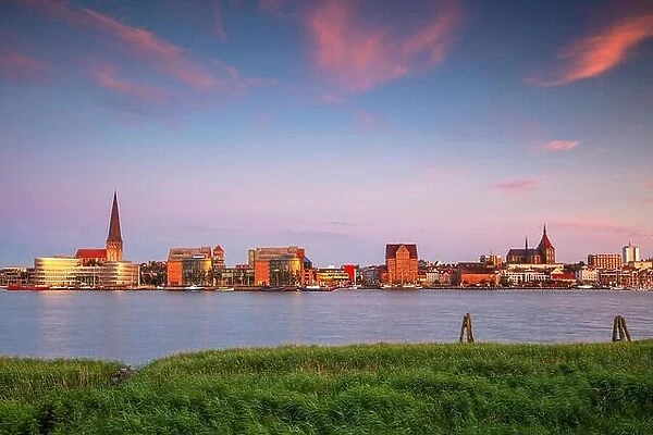 Rostock, Germany. Cityscape image of Rostock riverside with St. Peter's Church during summer sunset