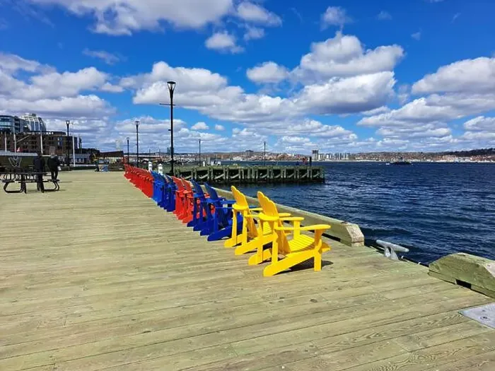 Framed Print : Row of colorful Adirondack chairs at the waterfront boardwalk in Halifax, Nova Scotia, Canada Framed Print : Row of colorful Adirondack chairs at the waterfront boardwalk in Halifax, Nova Scotia, Canada