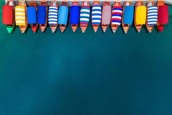 Framed Print : Row of Colorful Boats on Blue Lake. Top Down Drone View. Travel Background Framed Print : Row of Colorful Boats on Blue Lake. Top Down Drone View. Travel Background